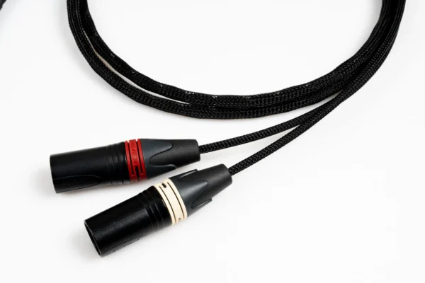 專業平衡音訊傳輸線 XLR 接頭近照，展示用於提升解碼器信噪比與減少聲道串擾的平衡驅動硬體基礎。